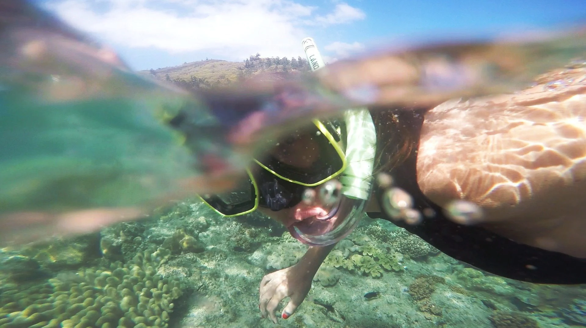 Woman snorkeling over a coral reef